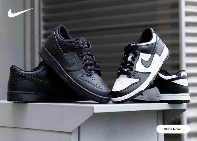A pair of Nike Dunk Low "Black" Shoe sitting next to a pair of Nike Dunk Low Black/White Shoes "Shop Now"